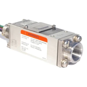 Close-up of a compact pressure switch for hydraulic applications. The switch is silver, with a warning label. It has threads for connecting to a hydraulic system.
