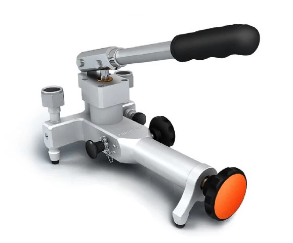 ADT 914 pneumatic hand pump. Close-up of a silver and black pneumatic hand pump with an orange knob. Precision instrument for pressure calibration.