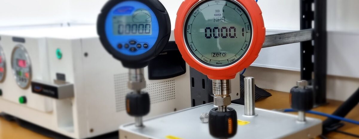 Pressure measurement setup showing digital pressure gauges, illustrating temperature compensation's importance for accurate readings.