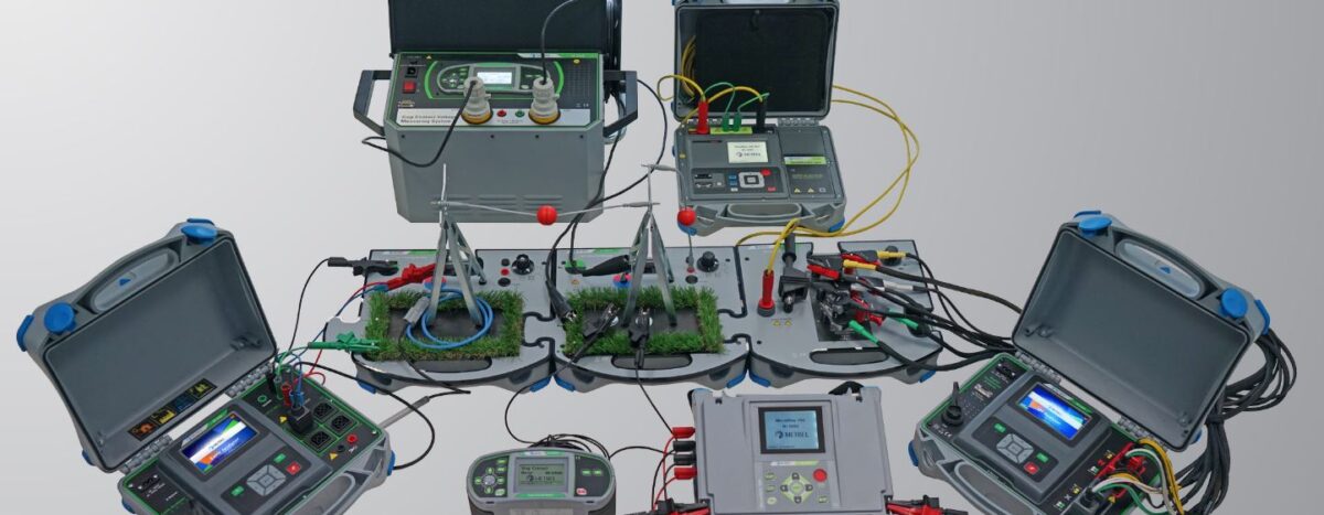 Metrel LV and HV Electrical Safety Training Equipment. Various testers, trainers, and simulators with connected wires and test leads.