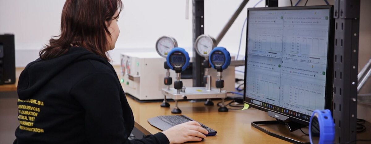 Calibration services: Technician performing equipment calibration, using computer software and precision instruments for accurate testing.